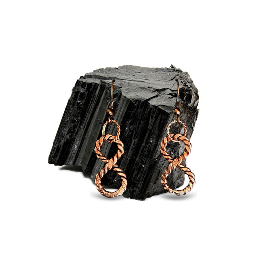 Infinity Copper healing earrings on black stone