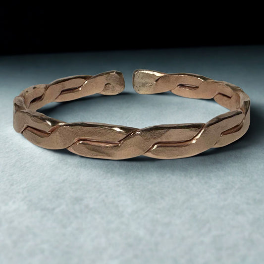 Copper EMF Protection braided bracelet on a light gray background