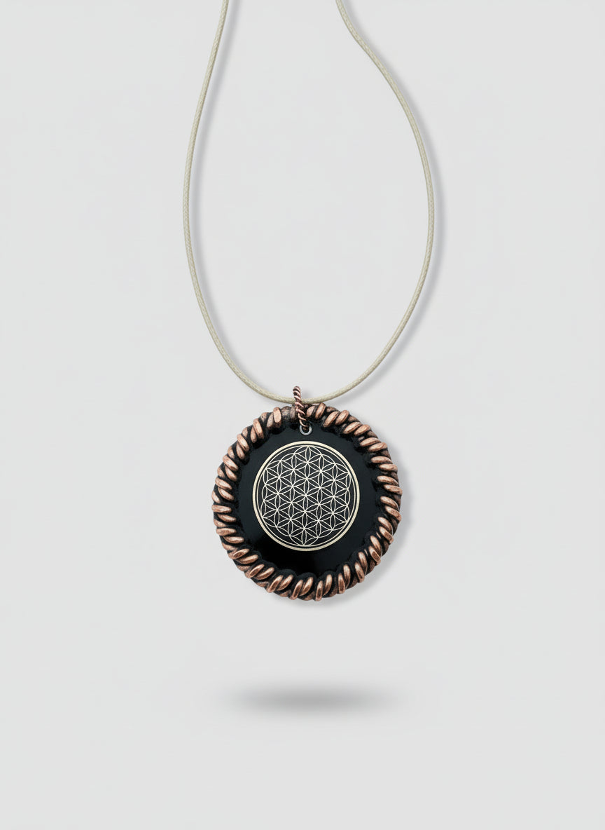 Necklace with a circular pendant featuring a flower of life design on a wooden surface