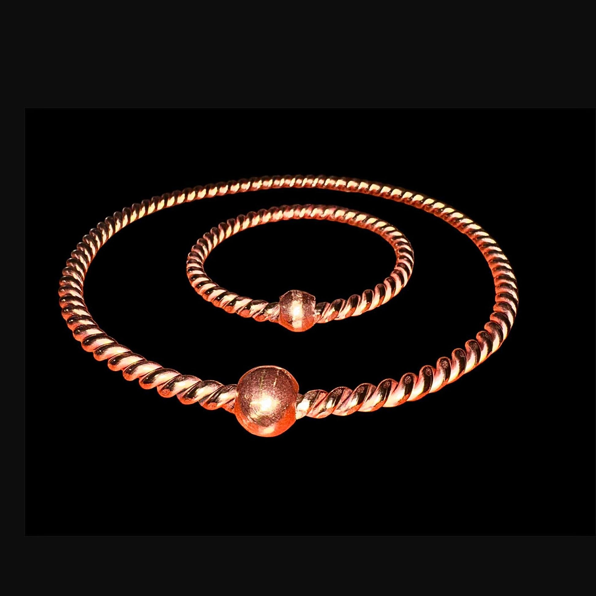 copper ring with bead accents on a black background