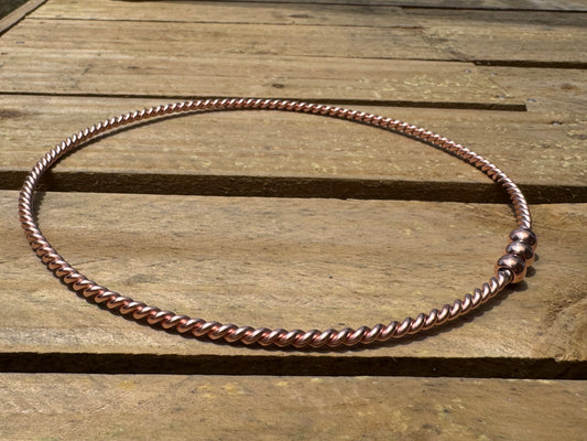 Copper ring EMF on a wooden surface