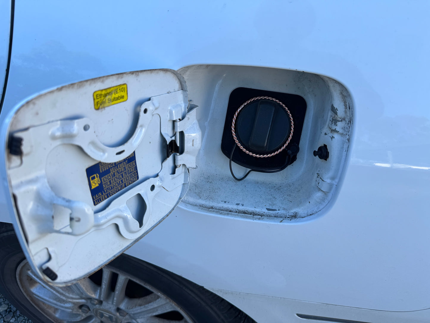 Electric vehicle charging port on a white car