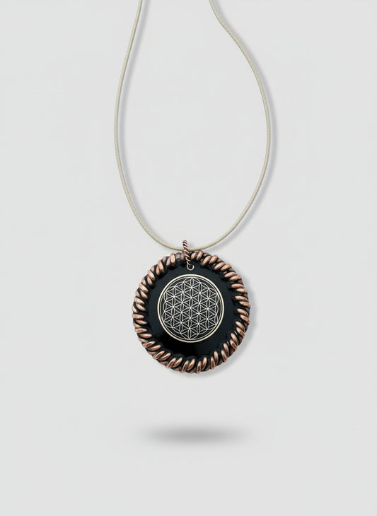 Necklace with a circular pendant featuring a flower of life design on a wooden surface