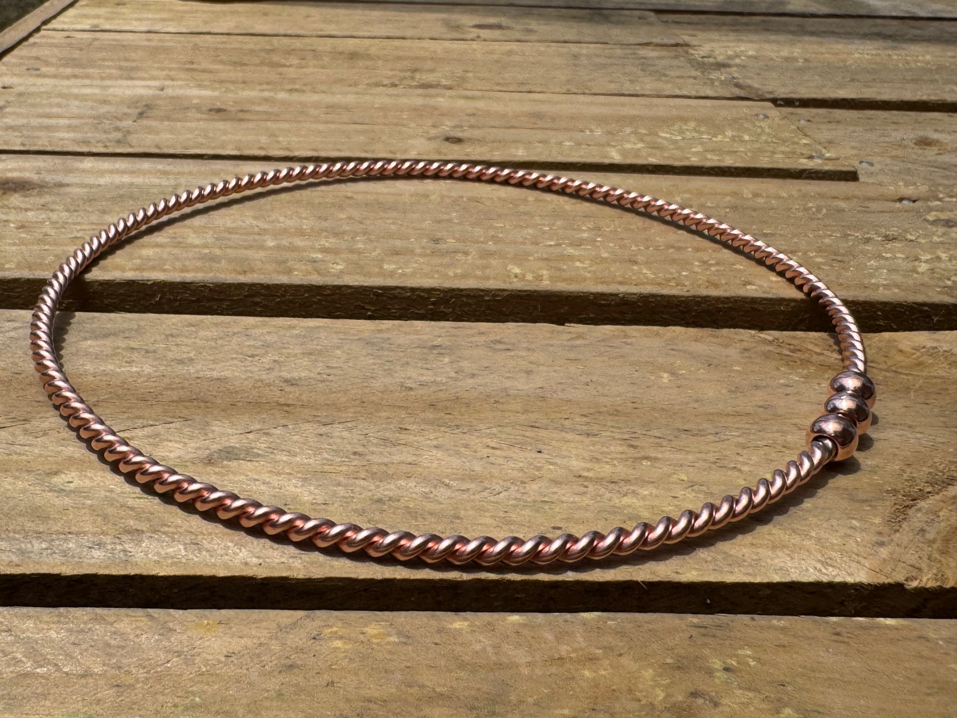 Copper ring EMF on a wooden surface