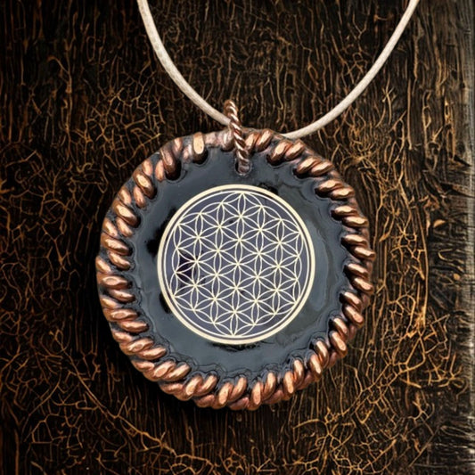 EMF Necklace with a pendant featuring a geometric design on a textured brown background