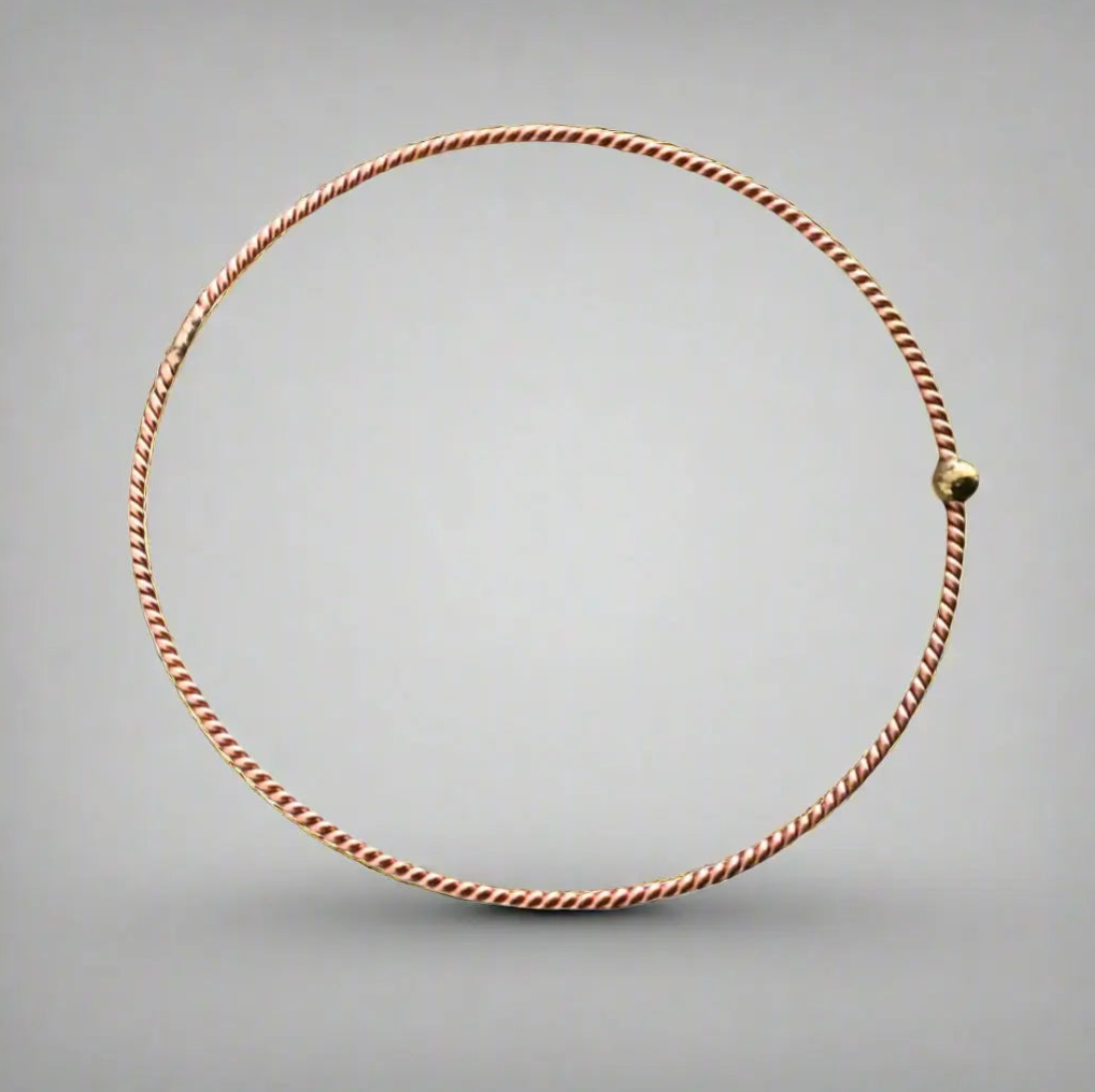 copper tensor ring on a gray background